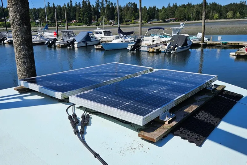 Slide: The Image of Solar panels on a 1975 Trawler Monterey Diesel Cruiser docked at a marina. - 17