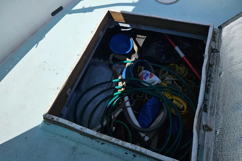Slide: The Image of Storage compartment on 1975 Trawler Monterey Diesel Cruiser with ropes and equipment. - 18