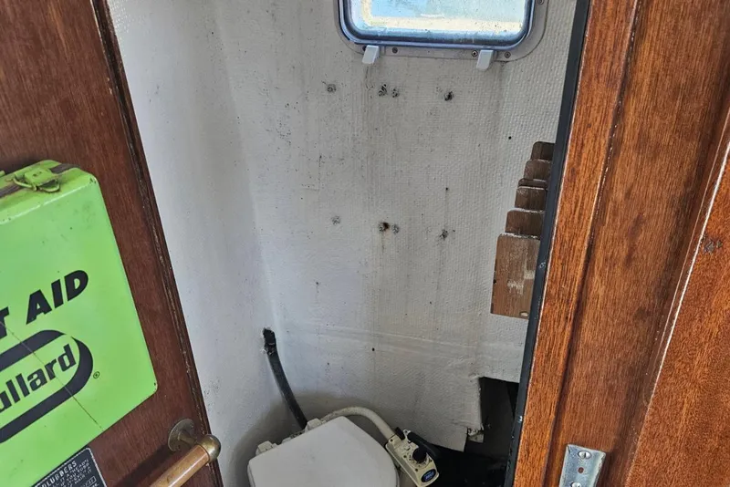 Slide: The Image of 1975 Trawler Monterey Diesel Cruiser bathroom with window and first aid kit. - 19