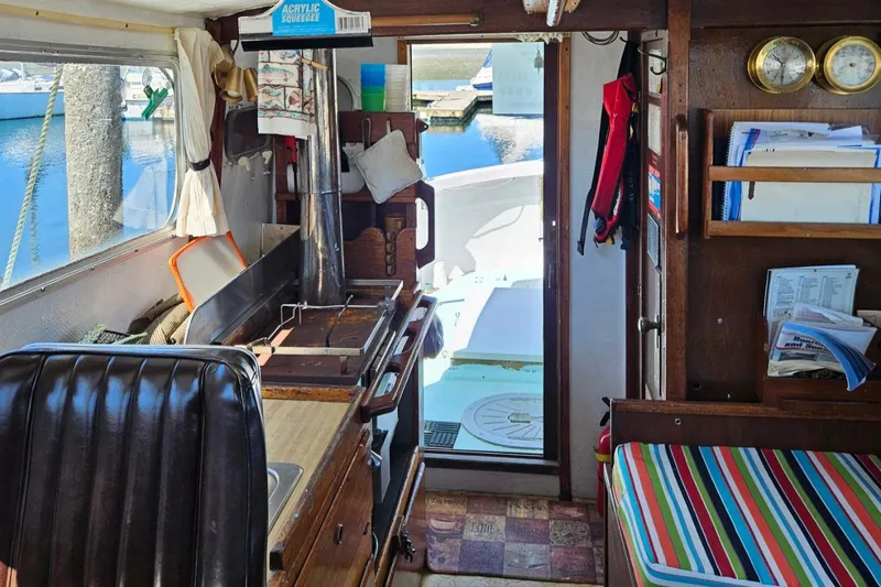 Slide: The Image of Interior of 1975 Trawler Monterey Diesel Cruiser with kitchen and seating area. - 2