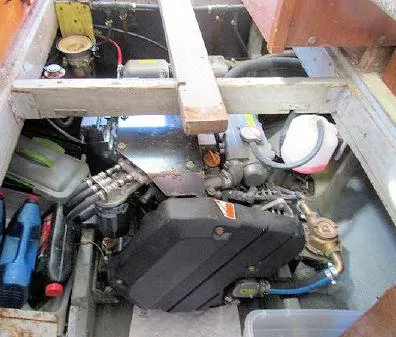 Slide: The Image of 1975 Trawler Monterey Diesel Cruiser engine compartment with visible components and tools. - 21