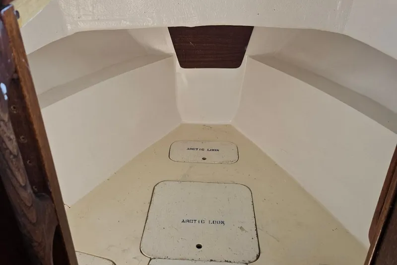 Slide: The Image of 1975 Monterey Diesel Cruiser Trawler interior with storage compartments and wooden accents. - 24