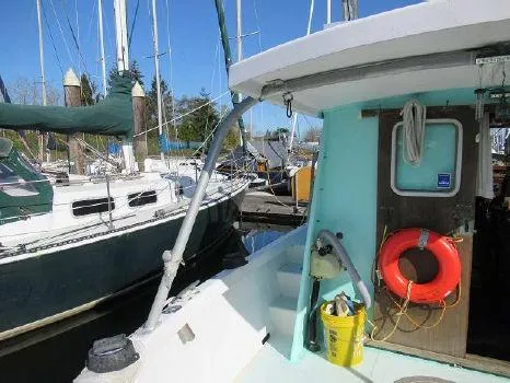 Slide: The Image of 1975 Trawler Monterey Diesel Cruiser docked, featuring a lifebuoy and nautical equipment. - 8