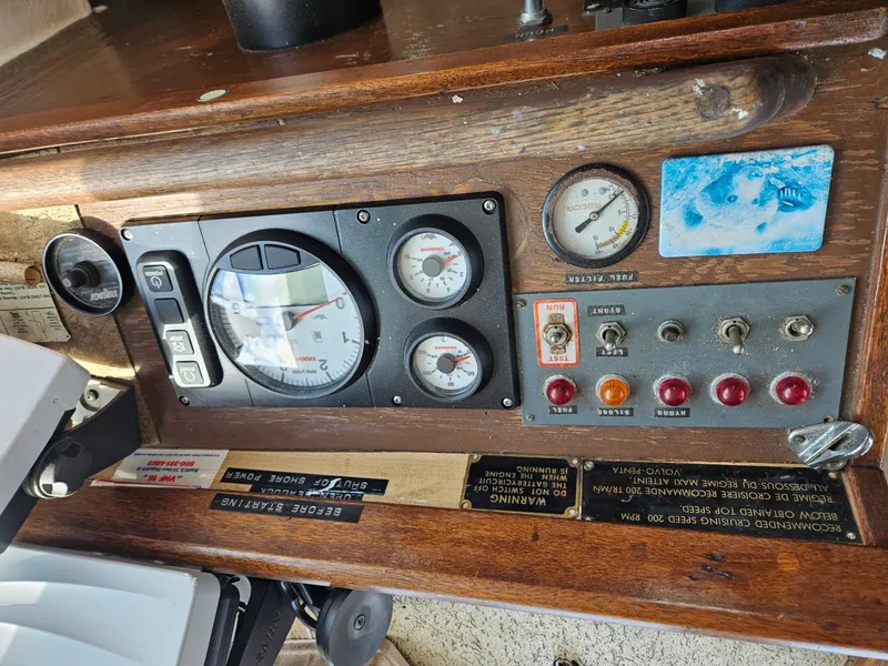 Slide: The Image of Control panel of a 1975 Trawler Monterey Diesel Cruiser with gauges and switches. - 9