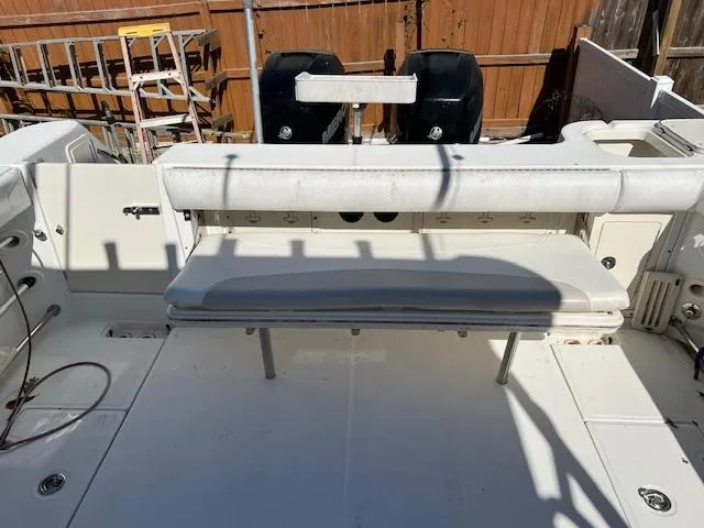 Slide: The Image of 2008 Boston Whaler 305 Conquest boat deck with seating and dual engines. - 10