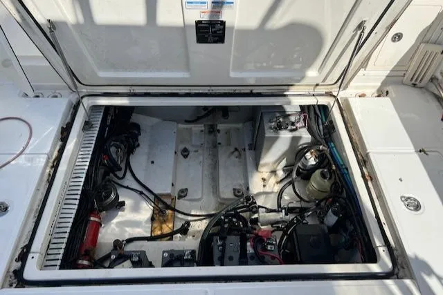 Slide: The Image of Engine compartment of 2008 Boston Whaler 305 Conquest, showcasing wiring and components. - 13