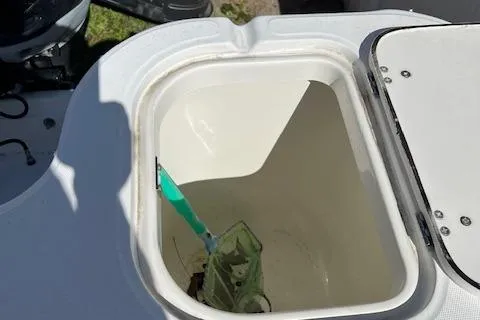 Slide: The Image of Livewell compartment on a 2008 Boston Whaler 305 Conquest boat, open with a net inside. - 14