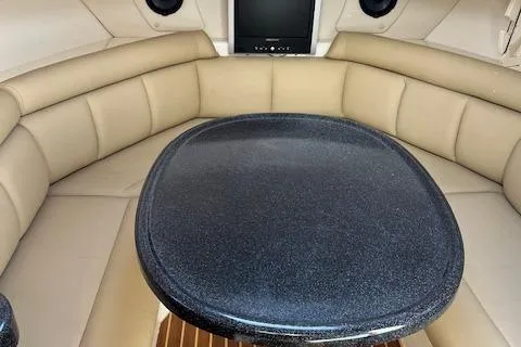 Slide: The Image of Interior of 2008 Boston Whaler 305 Conquest with cushioned seating and table. - 19