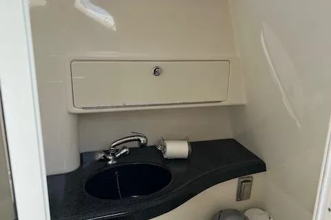 Slide: The Image of 2008 Boston Whaler 305 Conquest bathroom with sink and storage cabinet. - 20