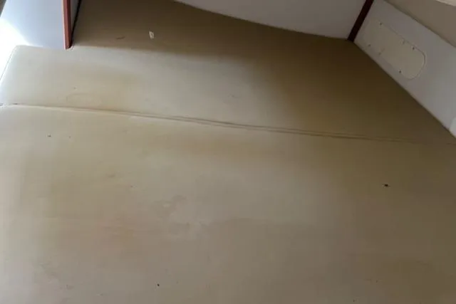 Slide: The Image of 2008 Boston Whaler 305 Conquest cabin interior with beige upholstery. - 22