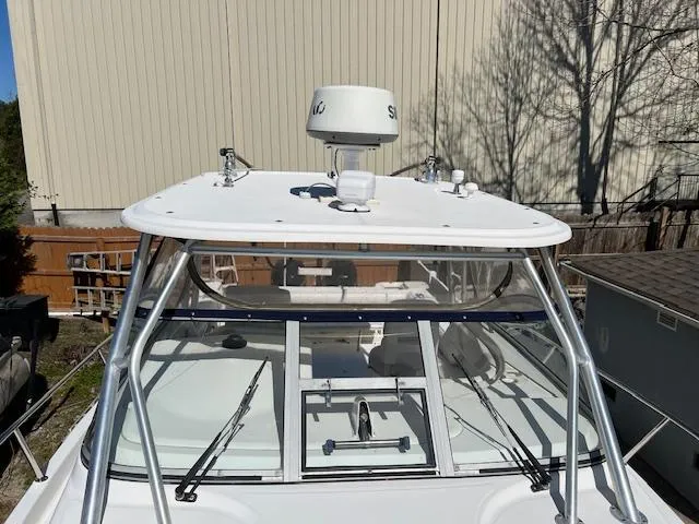 Slide: The Image of 2008 Boston Whaler 305 Conquest boat with radar, windshield, and sturdy frame. - 4