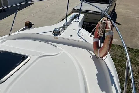 Slide: The Image of 2008 Boston Whaler 305 Conquest boat deck with life preserver and railing. - 6