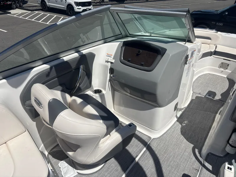 Slide: The Image of 2017 Chaparral 264 Sunesta Surf boat interior with helm and seating area. - 10