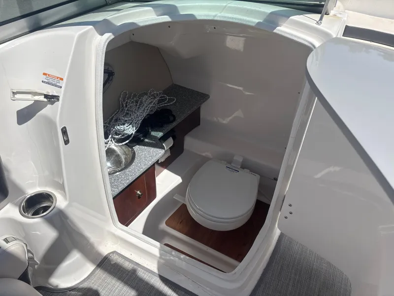 Slide: The Image of 2017 Chaparral 264 Sunesta Surf boat interior with toilet and sink. - 11