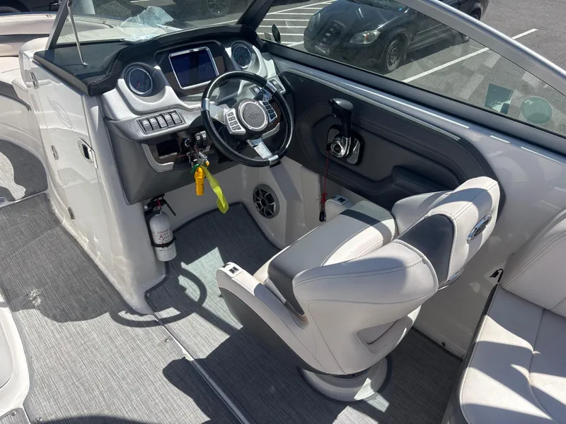 Slide: The Image of 2017 Chaparral 264 Sunesta Surf boat interior with steering wheel and dashboard controls. - 12