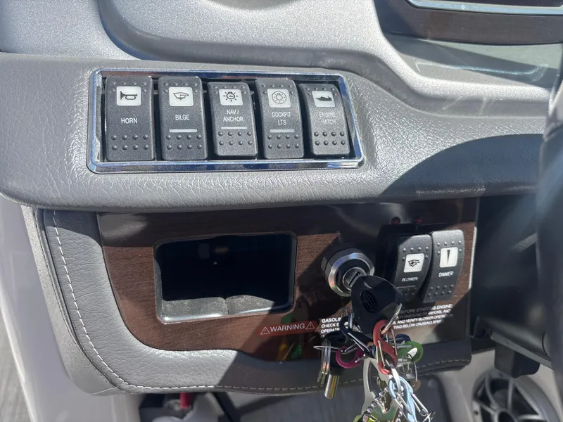 Slide: The Image of Control panel of 2017 Chaparral 264 Sunesta Surf boat with switches and ignition keys. - 14