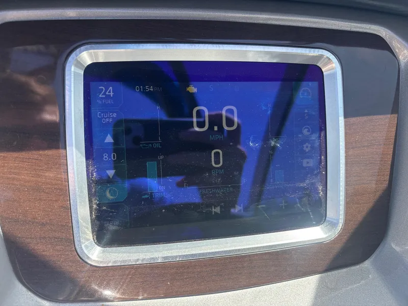 Slide: The Image of Dashboard display of a 2017 Chaparral 264 Sunesta Surf boat showing speed and fuel levels. - 15