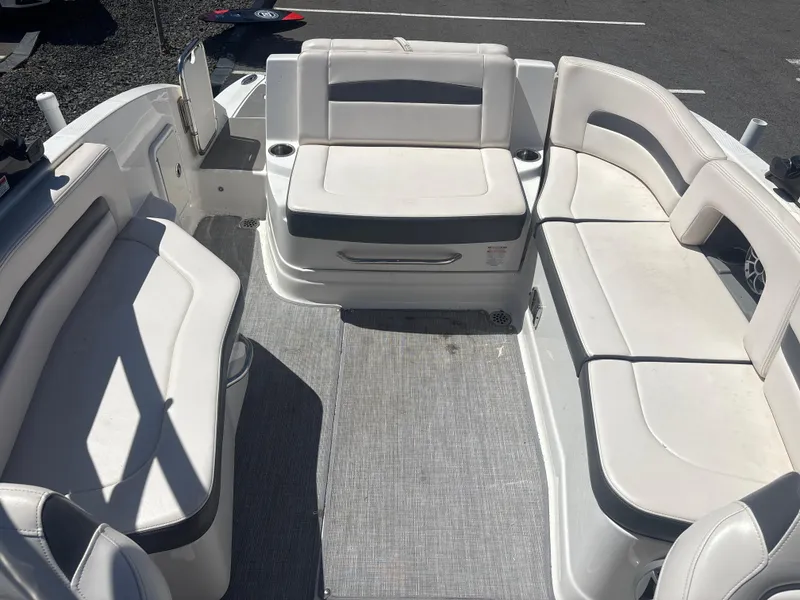 Slide: The Image of 2017 Chaparral 264 Sunesta Surf boat interior with white seating and gray flooring. - 18