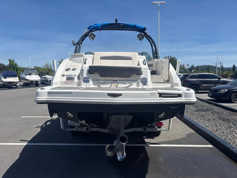 Slide: The Image of 2017 Chaparral 264 Sunesta Surf boat, rear view in parking lot, sunny day. - 4