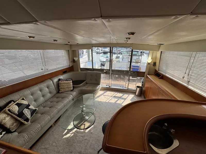 Slide: The Image of Luxurious interior of 1989 Birchwood 62 Cockpit Motor Yacht with elegant seating and glass table. - 20