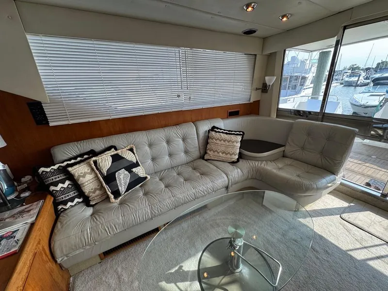Slide: The Image of Luxurious interior of 1989 Birchwood 62 Cockpit Motor Yacht with plush seating and glass table. - 21