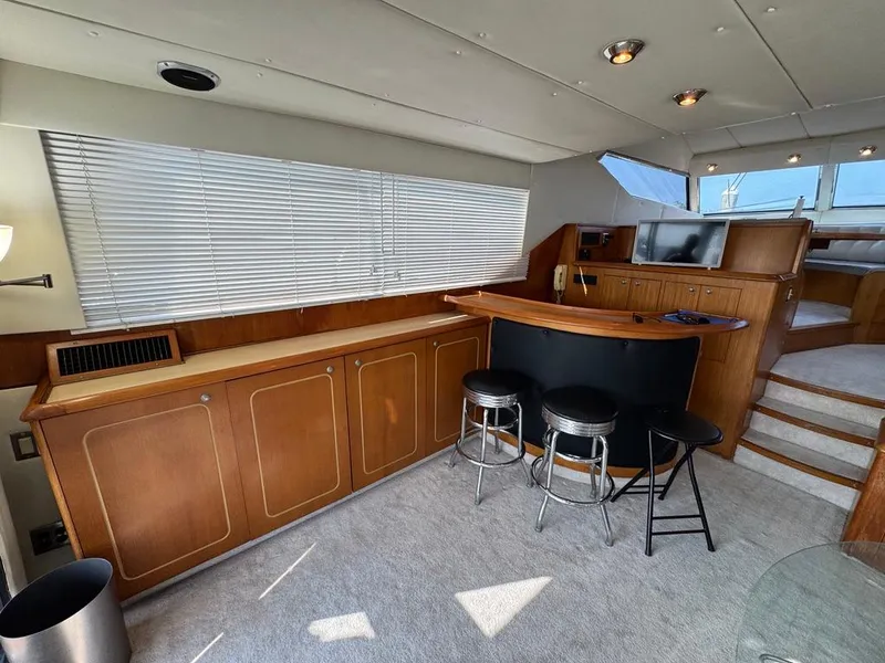 Slide: The Image of Luxurious interior of 1989 Birchwood 62 Cockpit Motor Yacht with bar and seating area. - 23
