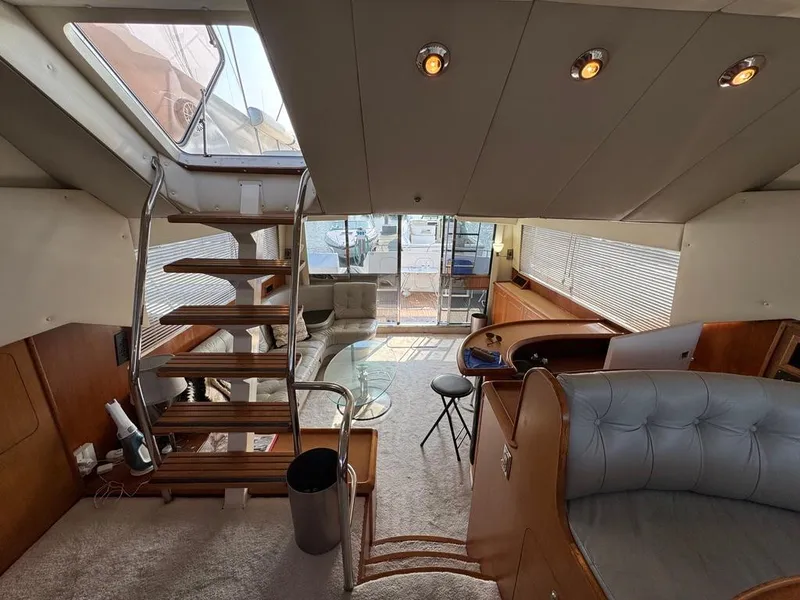 Slide: The Image of Interior of 1989 Birchwood 62 Cockpit Motor Yacht with modern seating and staircase. - 24