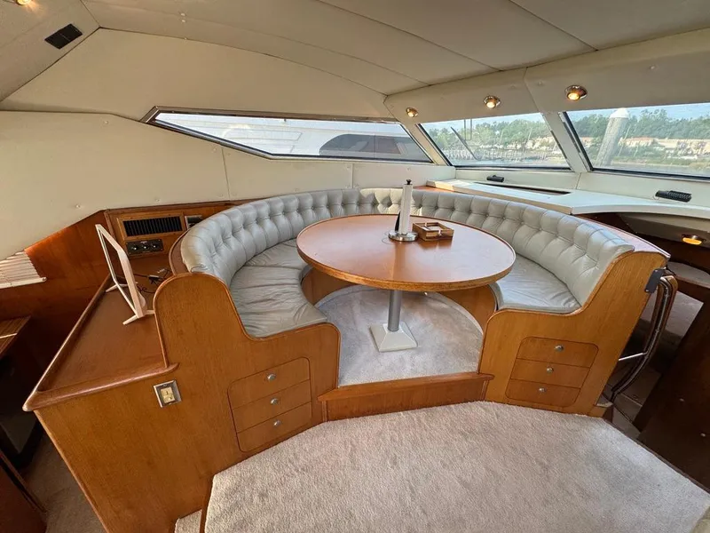 Slide: The Image of Luxurious 1989 Birchwood 62 Cockpit Motor Yacht interior with elegant circular seating and table. - 27