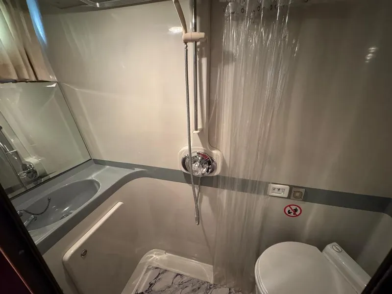 Slide: The Image of 1989 Birchwood 62 Cockpit Motor Yacht bathroom with shower, sink, and toilet. - 35