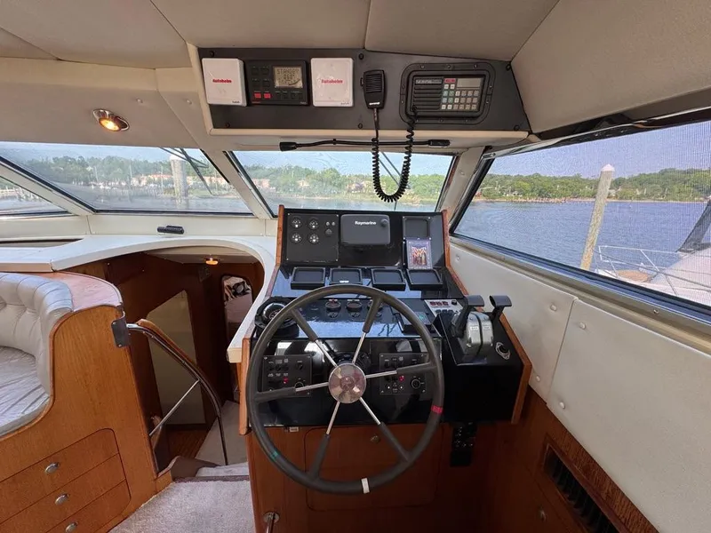 Slide: The Image of Cockpit of 1989 Birchwood 62 Cockpit Motor Yacht with steering wheel and navigation equipment. - 38
