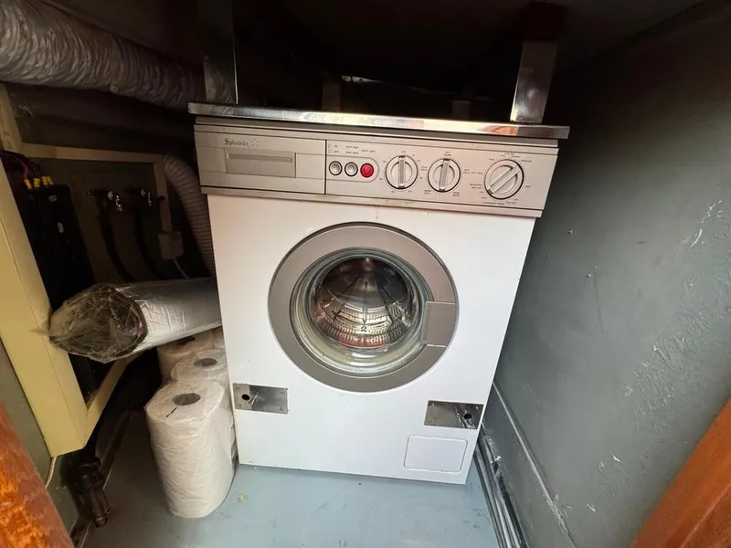 Slide: The Image of Washing machine in 1989 Birchwood 62 Cockpit Motor Yacht laundry area. - 39