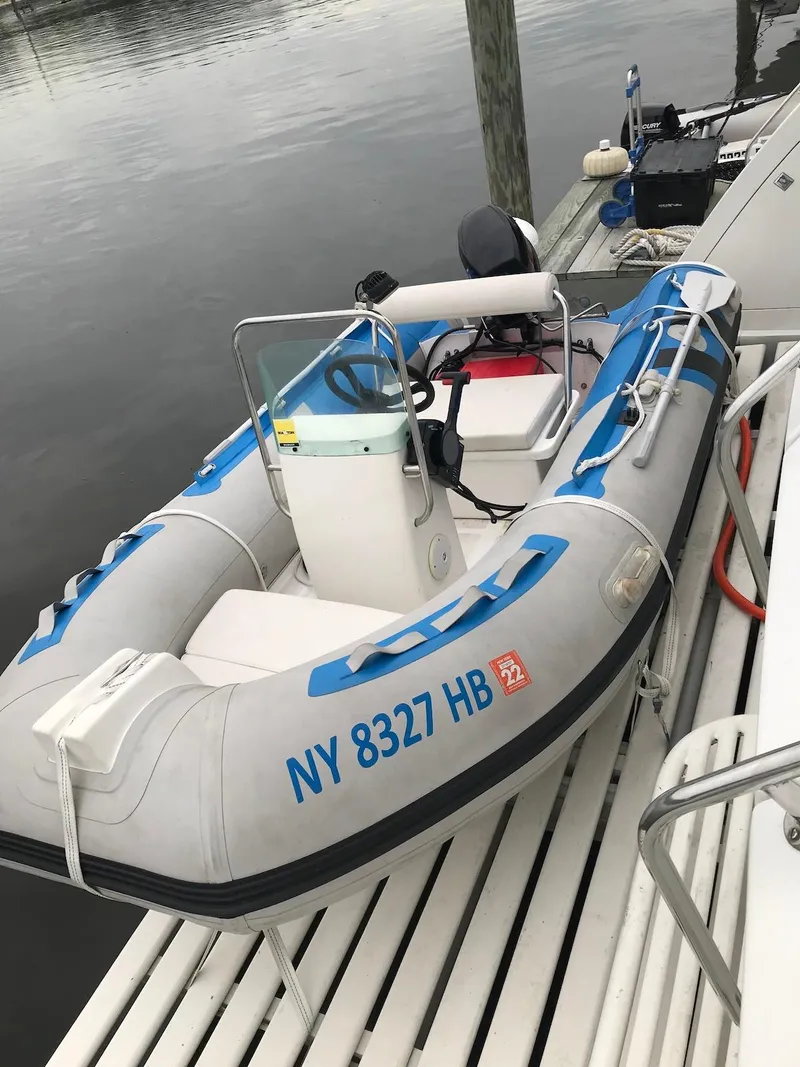 Slide: The Image of Inflatable boat docked beside a Birchwood 62 Cockpit Motor Yacht, 1989 model. - 40