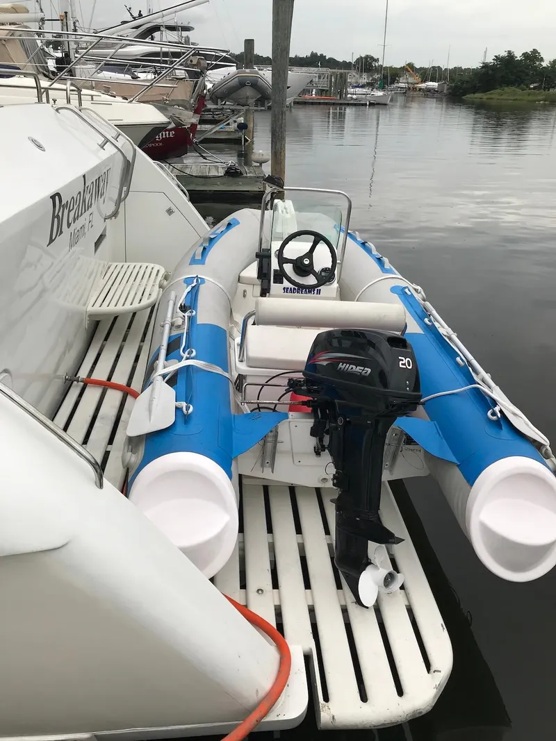 Slide: The Image of Inflatable boat with motor docked beside 1989 Birchwood 62 Cockpit Motor Yacht. - 41