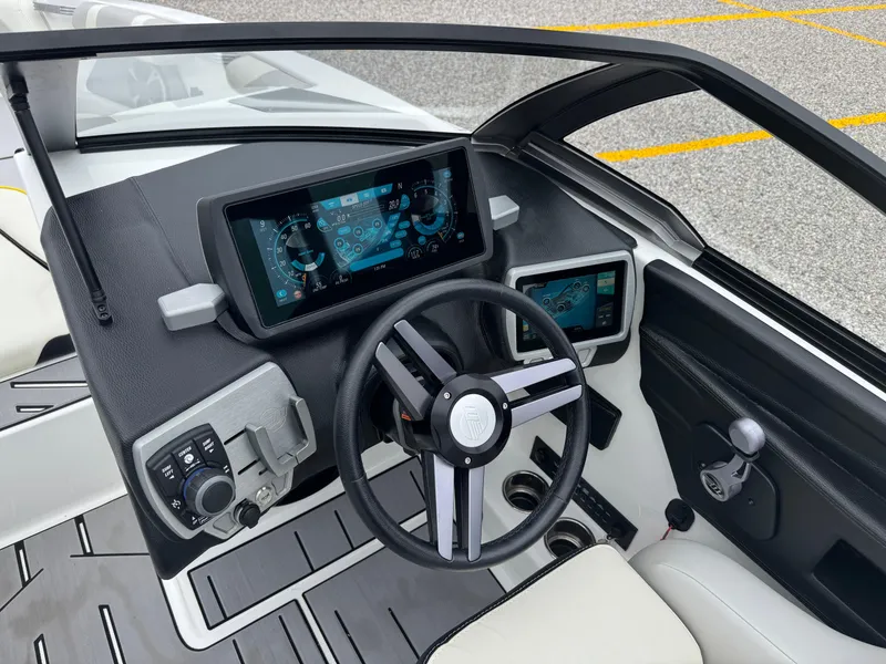 Slide: The Image of 2018 Malibu VLX boat dashboard with modern controls and digital displays. - 13