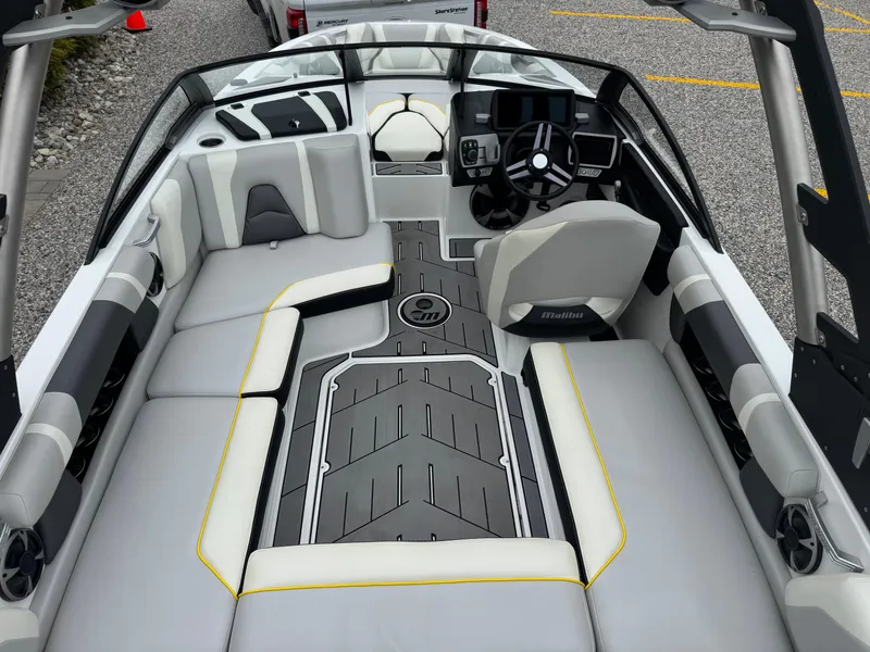 Slide: The Image of 2018 Malibu VLX boat interior with sleek seating and modern dashboard design. - 8