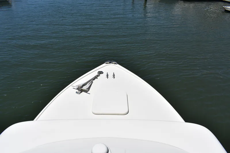 Slide: The Image of Bow of a 1965 Bertram 31 boat on calm water. - 11