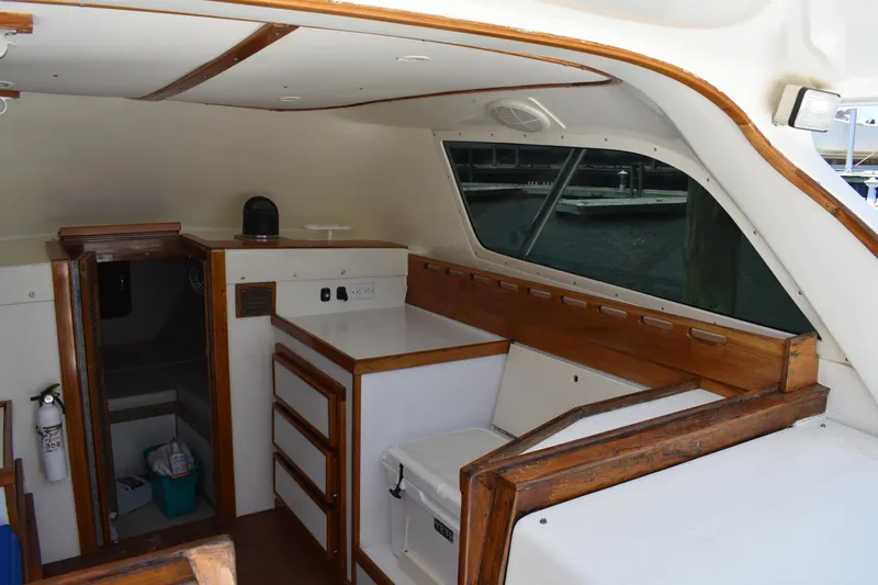 Slide: The Image of Interior of a 1965 Bertram 31 boat with wooden cabinetry and seating. - 16