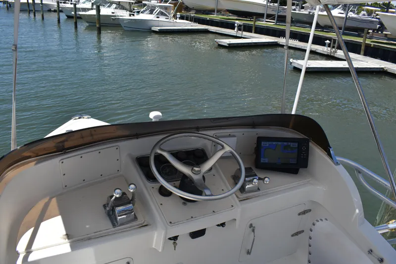 Slide: The Image of Helm of a 1965 Bertram 31 boat docked at a marina. - 9