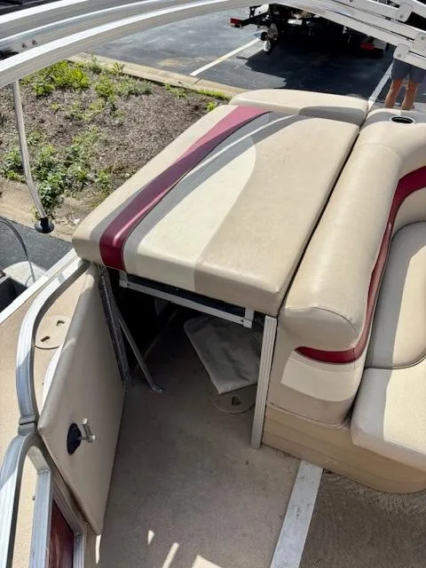 Slide: The Image of 2011 Bennington 20SLi pontoon boat interior with beige and red seating. - 11