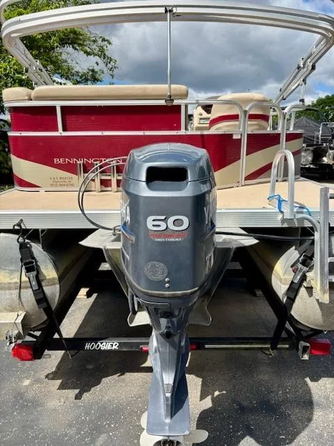 Slide: The Image of 2011 Bennington 20SLi pontoon boat with Yamaha 60HP outboard motor on trailer. - 2