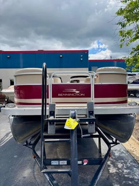 Slide: The Image of 2011 Bennington 20SLi pontoon boat on trailer, parked outdoors under cloudy sky. - 3