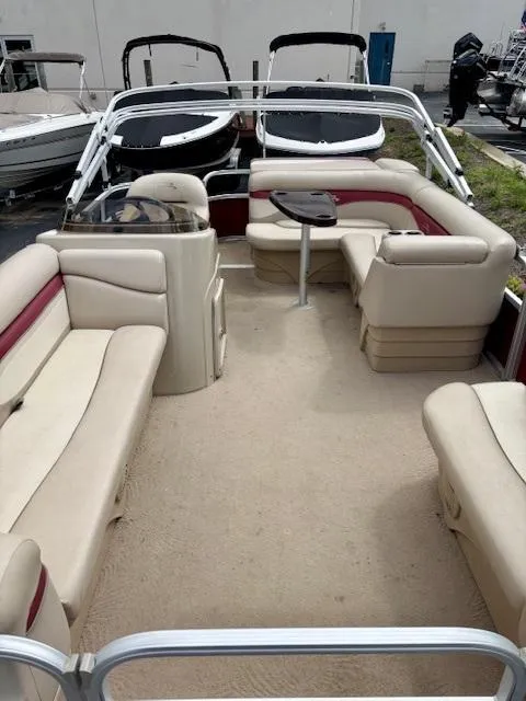 Slide: The Image of 2011 Bennington 20SLi pontoon boat with beige seating and a central table. - 6