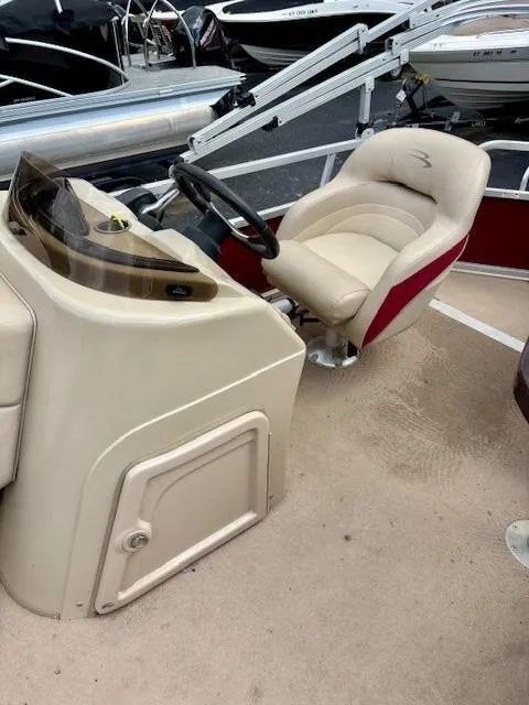 Slide: The Image of 2011 Bennington 20SLi boat interior with steering console and cushioned seat. - 8