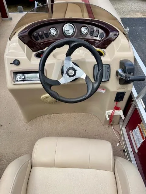 Slide: The Image of 2011 Bennington 20SLi boat dashboard with steering wheel and control panel. - 9