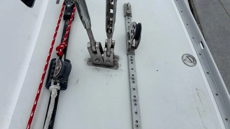 Slide: The Image of Deck hardware of a 2003 J Boats J/46 sailboat, featuring rigging and pulleys. - 15