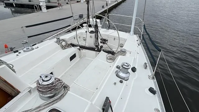 Slide: The Image of 2003 J Boats J/46 sailboat cockpit with winches and steering wheel at dock. - 16