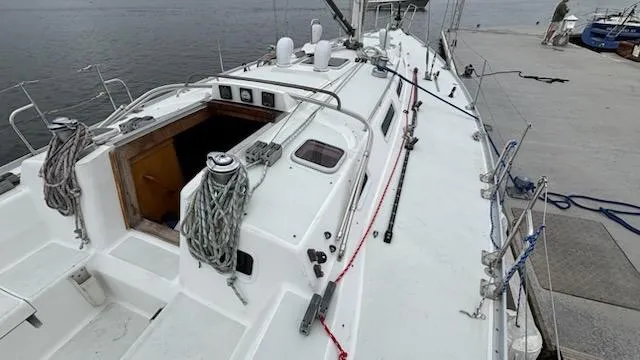 Slide: The Image of 2003 J Boats J/46 sailboat docked, showing deck and cabin entrance. - 17