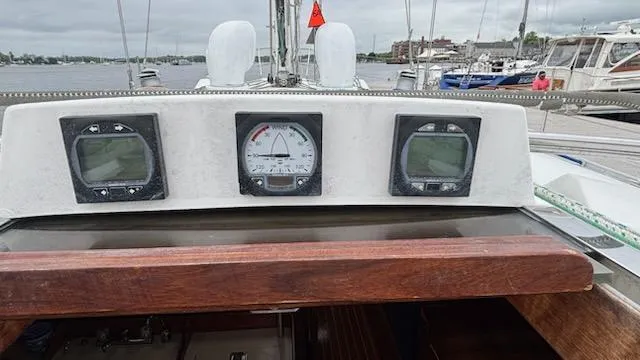 Slide: The Image of 2003 J Boats J/46 cockpit instruments with navigation displays and wooden trim. - 20