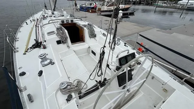 Slide: The Image of 2003 J Boats J/46 sailboat cockpit with steering wheel and navigation equipment at dock. - 21