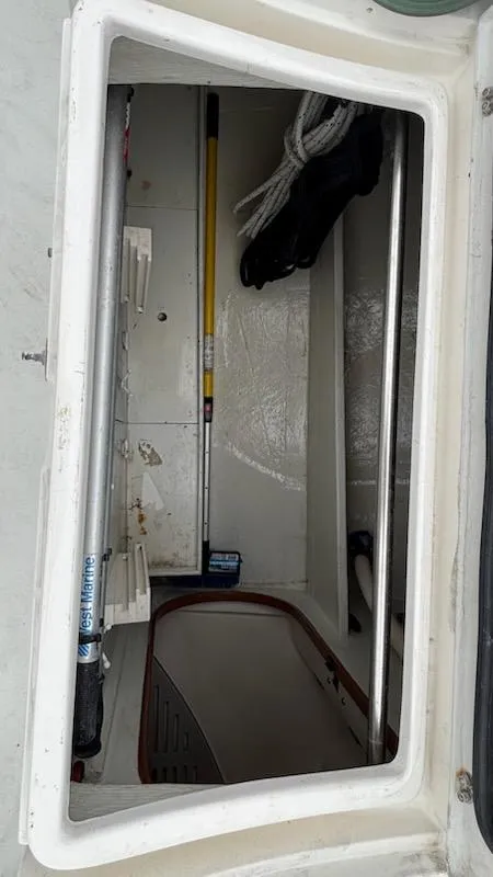 Slide: The Image of Storage compartment on a 2003 J Boats J/46 sailboat, featuring ropes and equipment. - 28